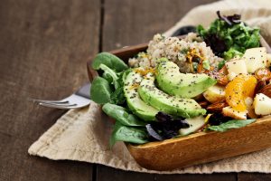 Quinoa, avocado and apple salad. Perfect for the detox diet or just a healthy meal. Selective focus on front of dish with extreme shallow depth of field.